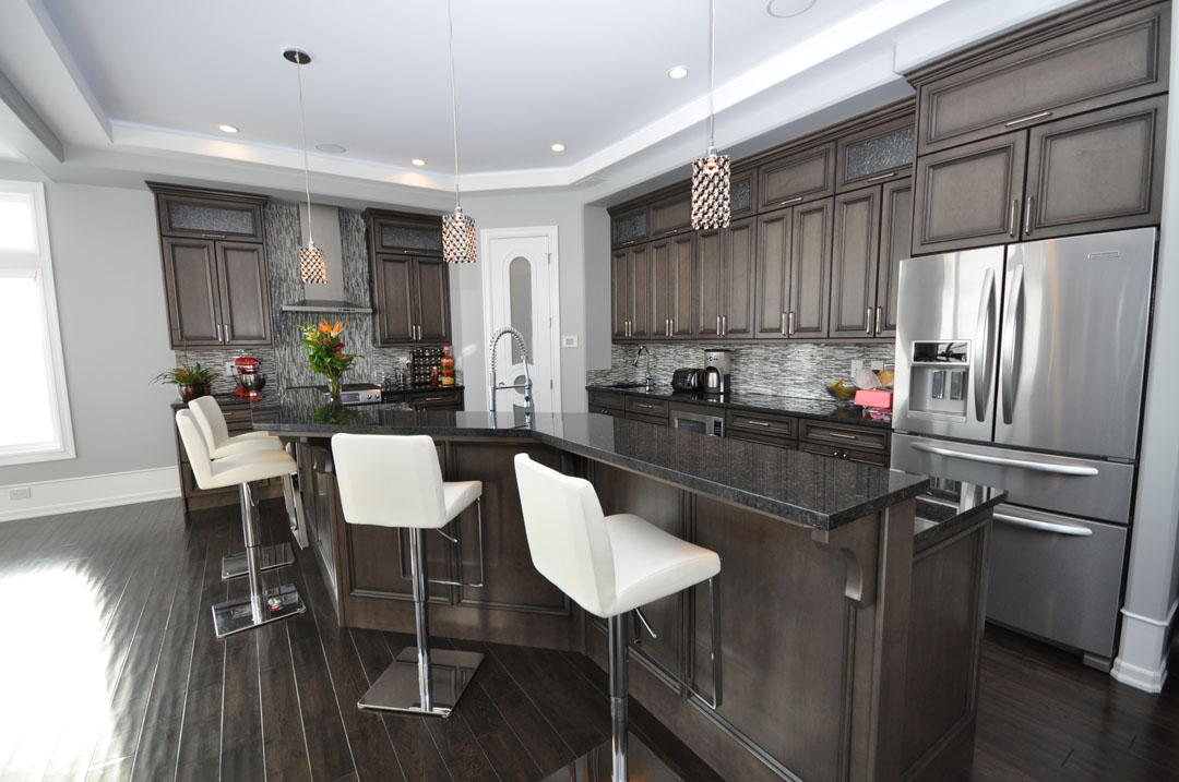 Custom kitchen with dark cabinetry and stone island