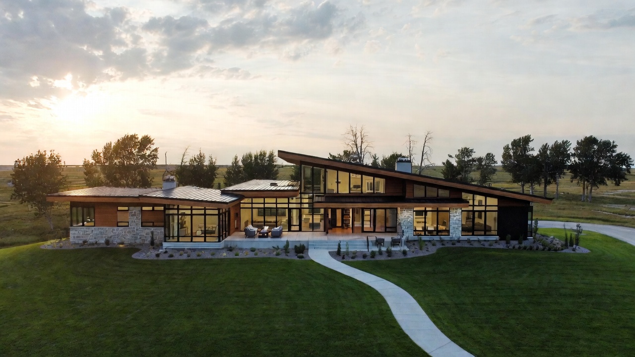 A contemporary glass and timber residence at dusk