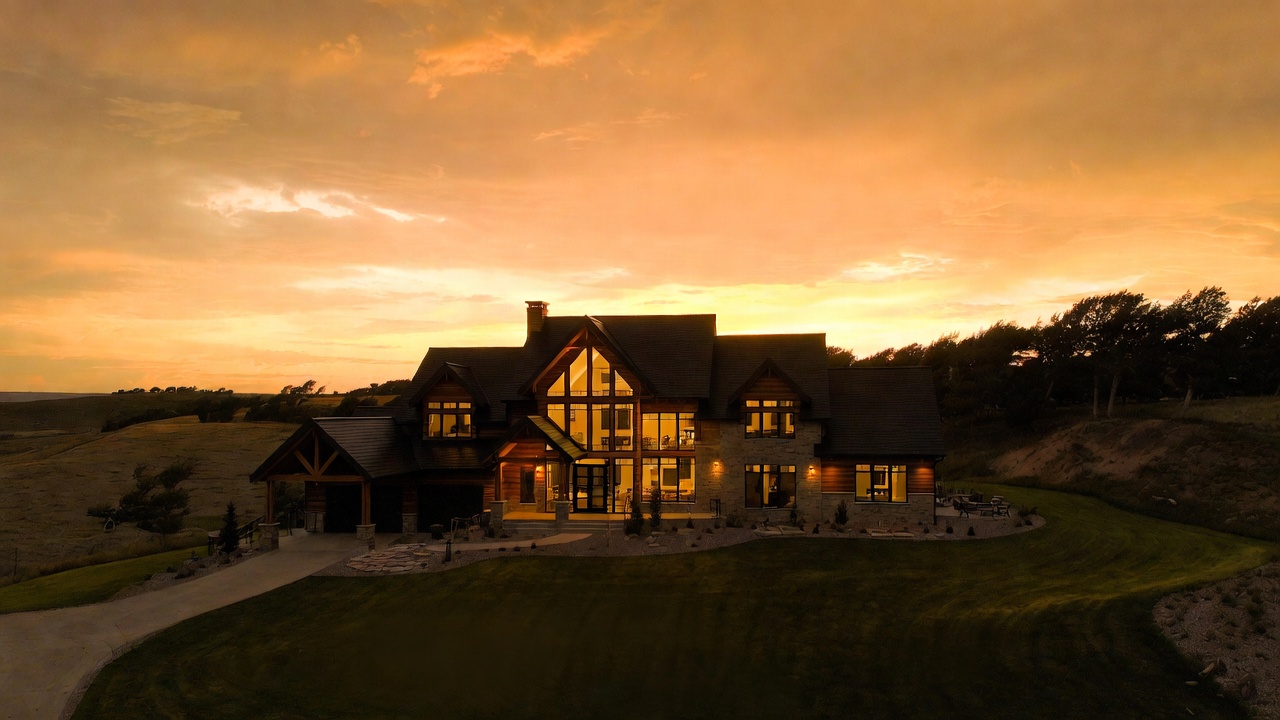 Timber and stone residence at sunset